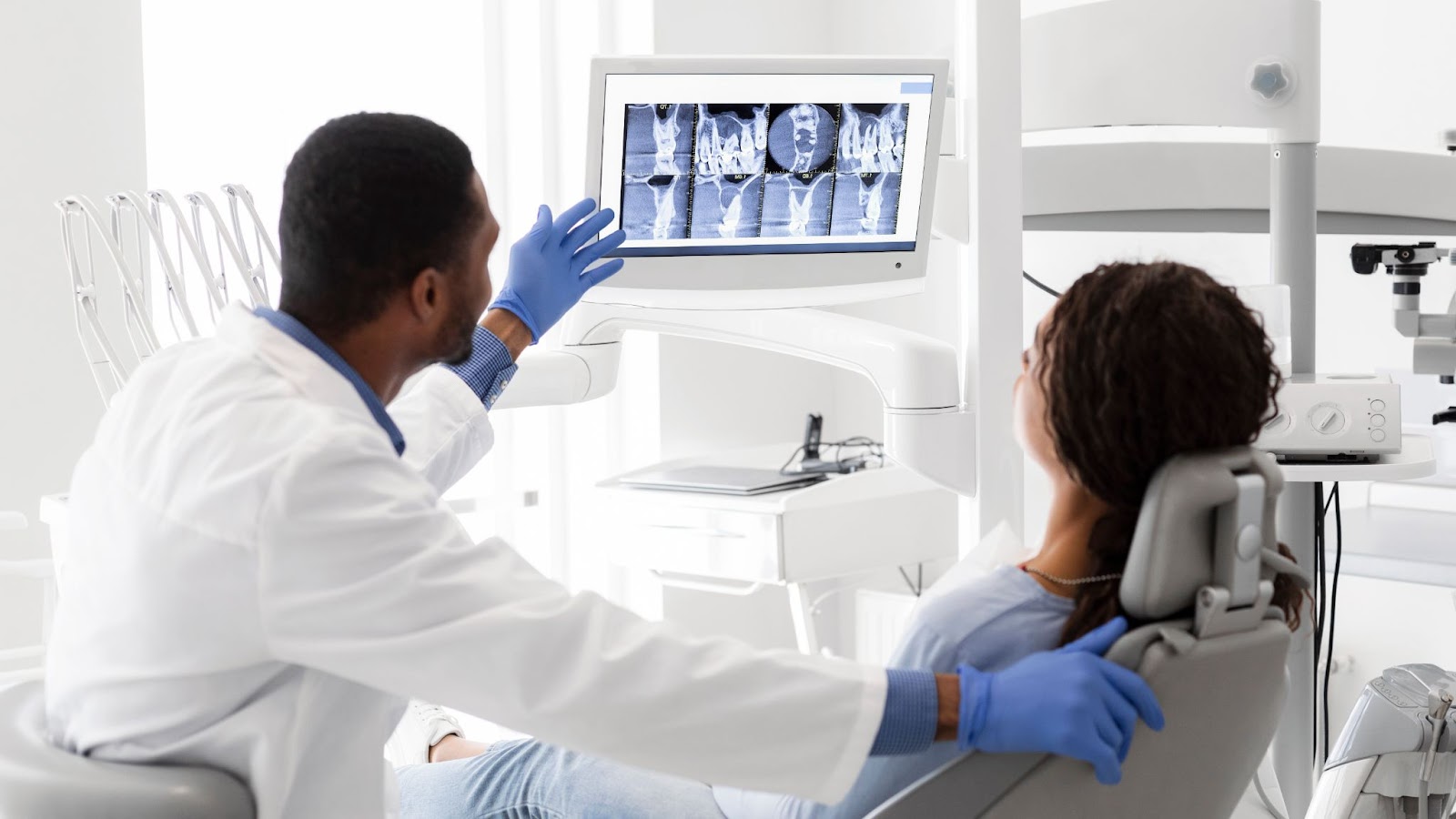 A dentist shows a patient detailed X-ray scans on a digital screen, explaining the results and discussing treatment options. Modern diagnostic tools ensure accurate results. Discover top-notch dental care with a dentist in Bradenton Florida who prioritizes your oral health.

