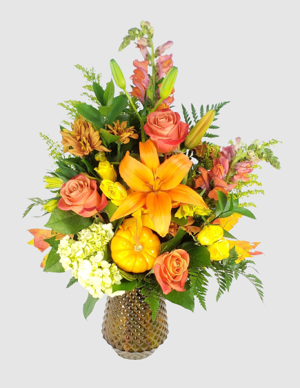 A bouquet of flowers in a vaseDescription automatically generated