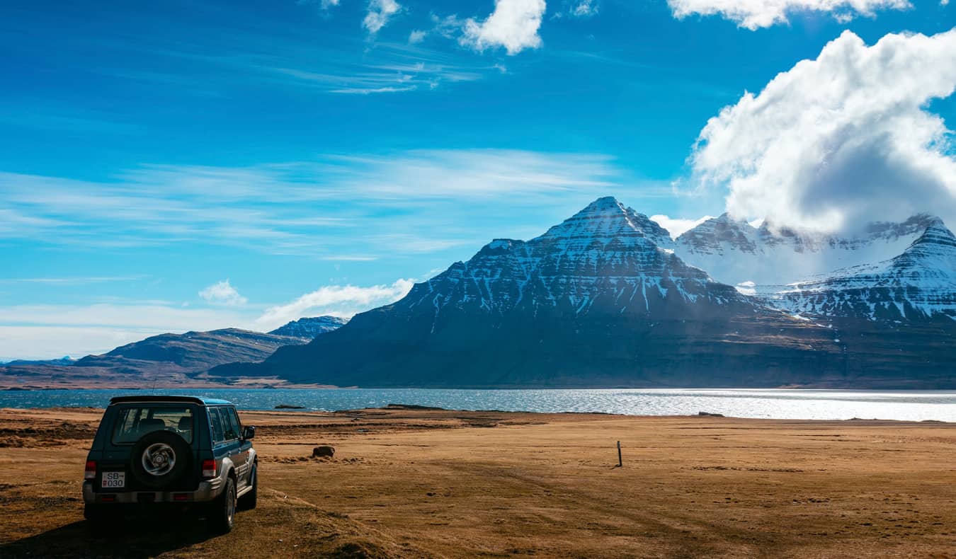 A car parked near the mountains in Iceland