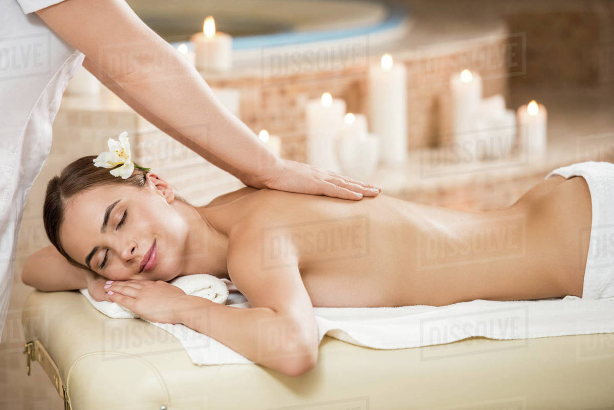 Massage therapist making massage for gorgeous woman in spa salon - Stock  Photo - Dissolve