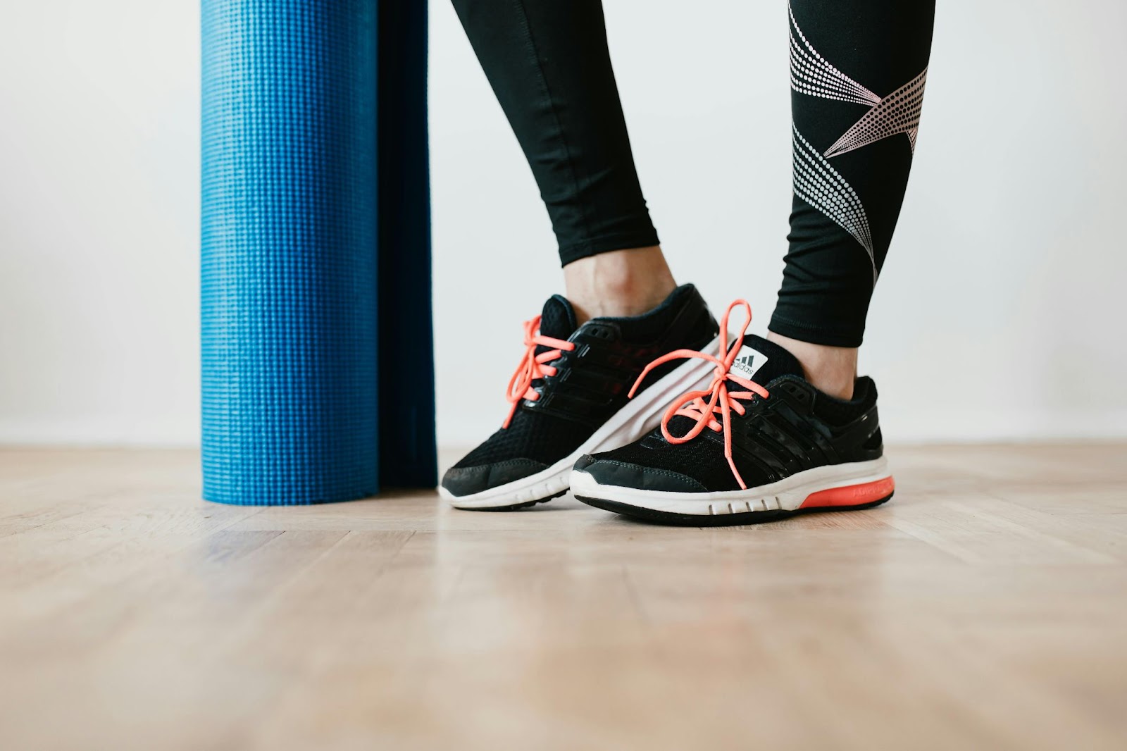 A picture of a yoga mat and person's ankles