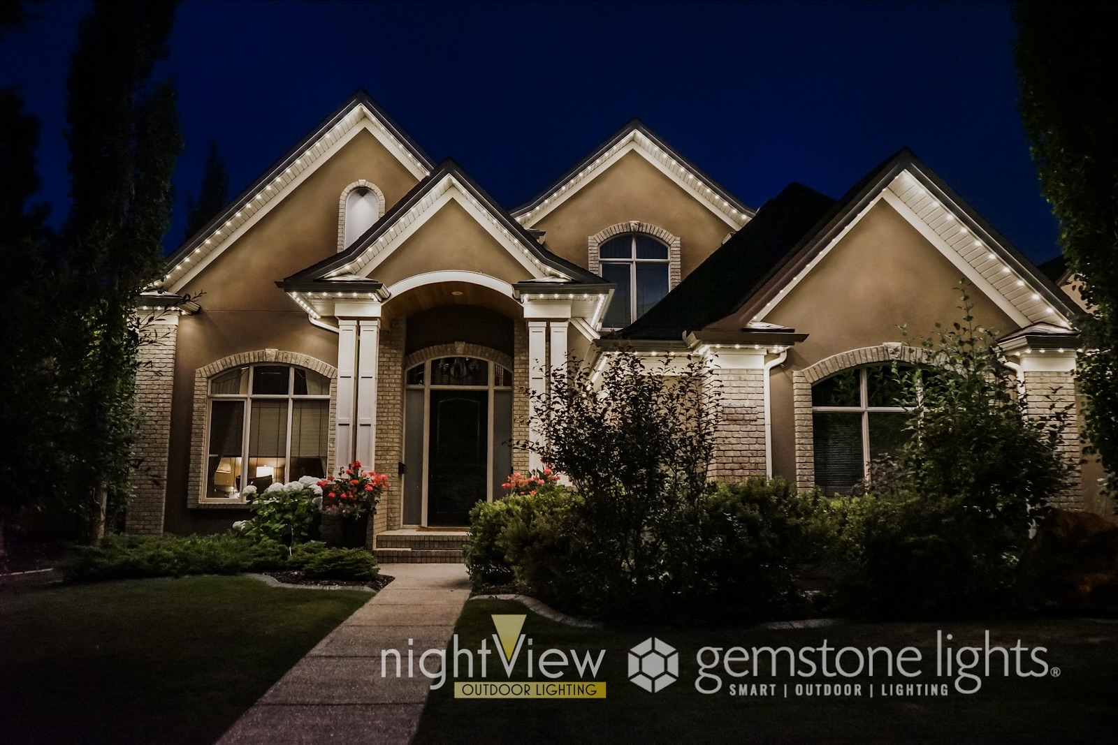 This property’s outdoor lighting design includes energy efficient LED permanent holiday lighting