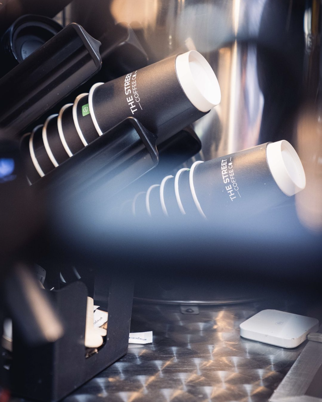 A close-up view of black paper coffee cups with 