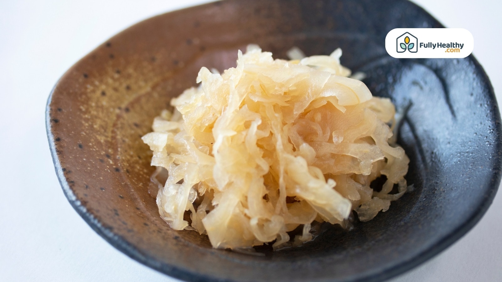 Fermented shredded cabbage served in a rustic ceramic bowl