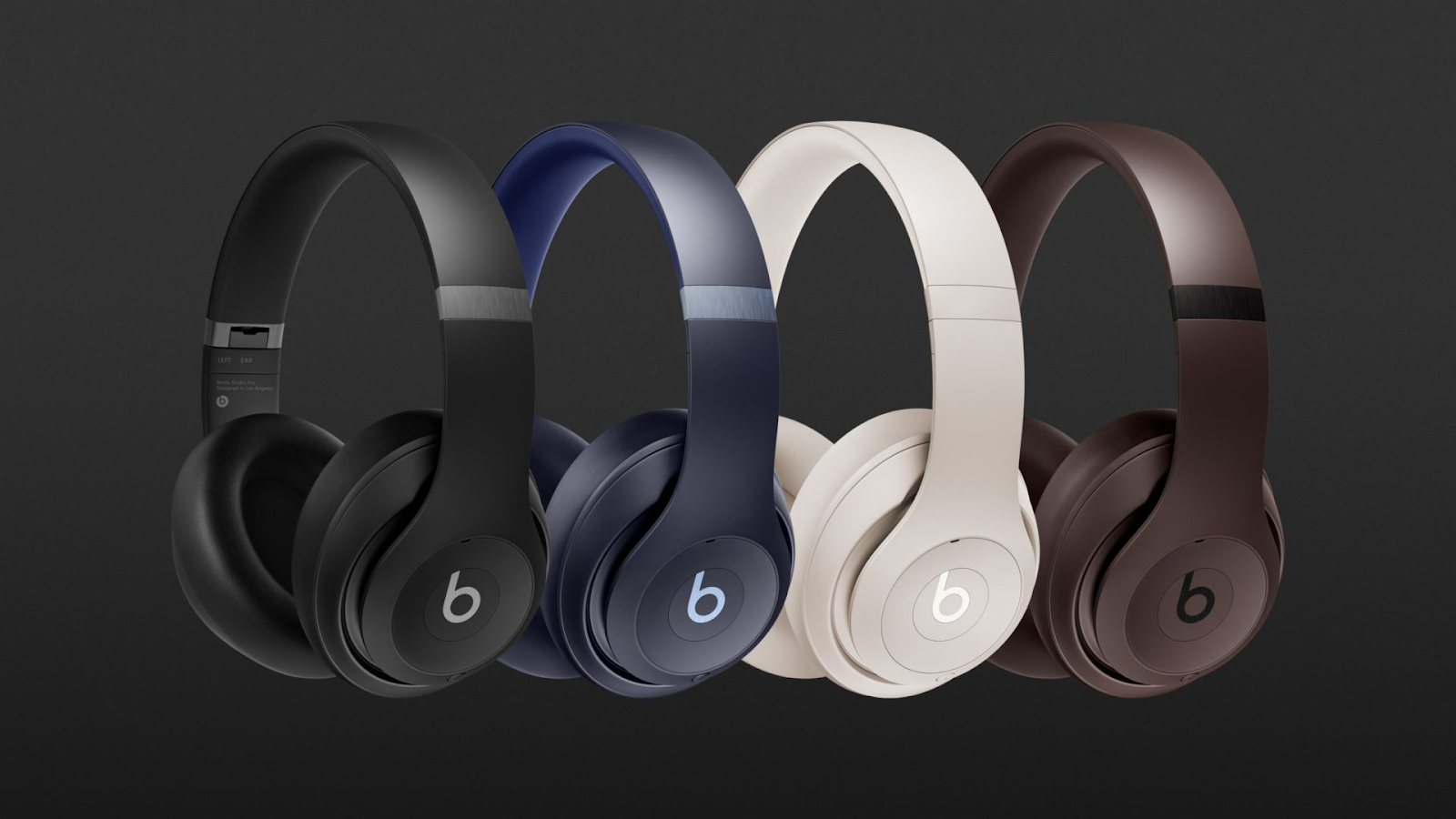 Beats Studio Pro headphones in four different colors: Sandstone, Navy, Espresso, and Black.