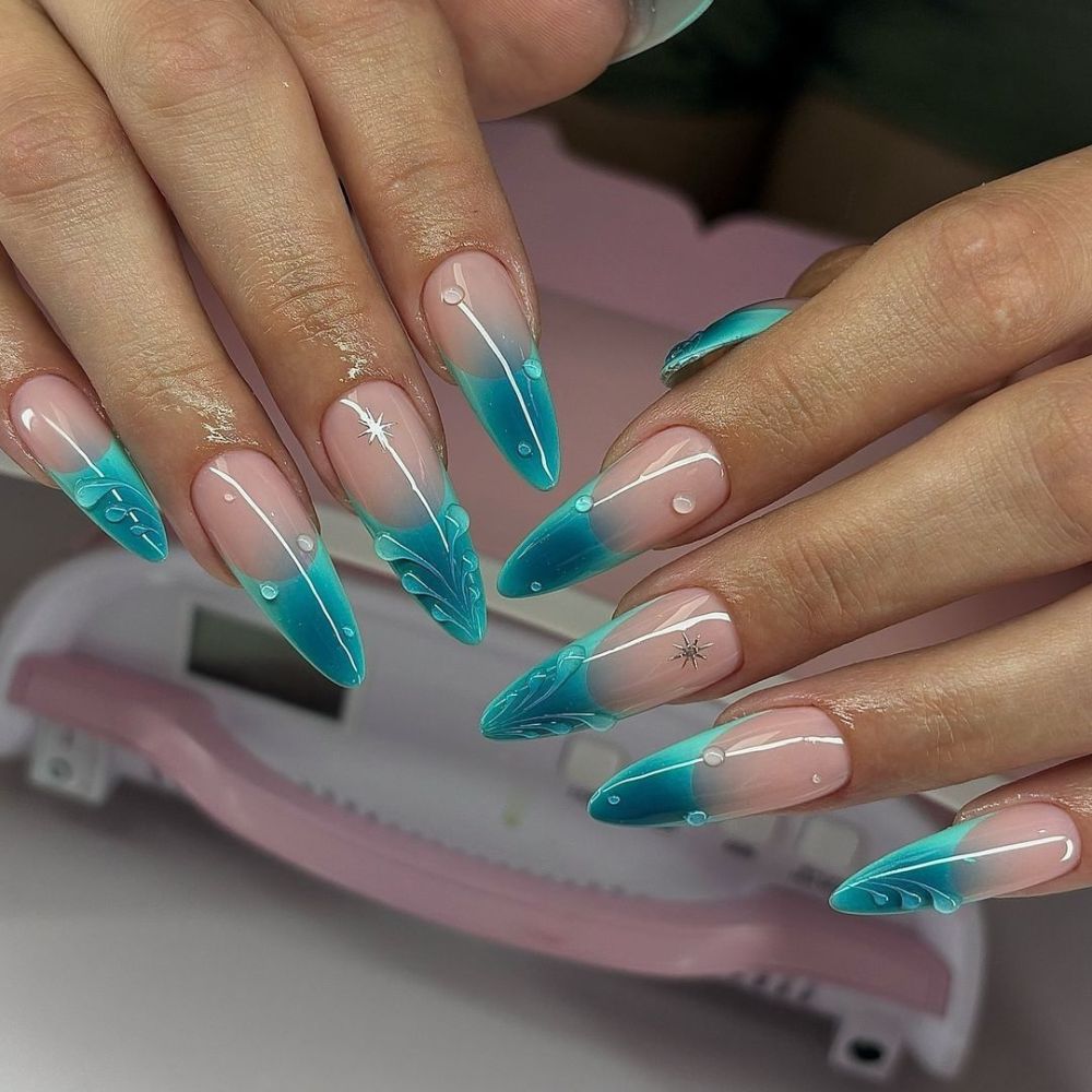 Close up of hands with blue winter nails having Ice melting effect 