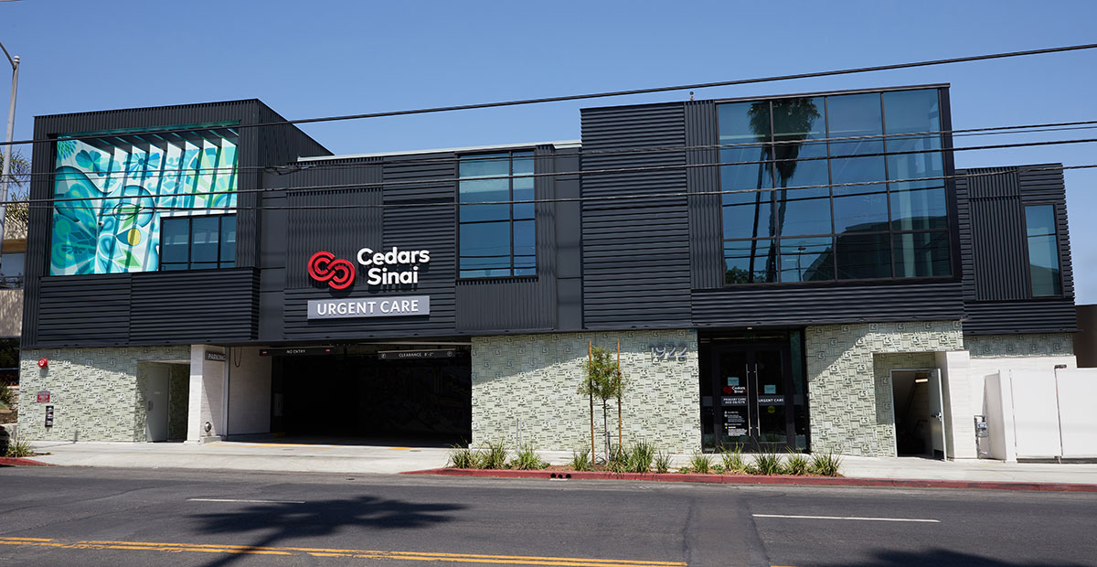 A modern building with large glass windows and a sign reading "Cedars Sinai Urgent Care" showcases the epitome of hospital design.