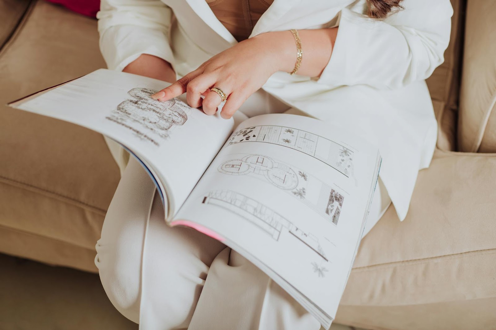 https://www.pexels.com/photo/close-up-of-an-elegant-woman-sitting-on-a-sofa-pointing-at-an-illustration-in-a-book-24366021/