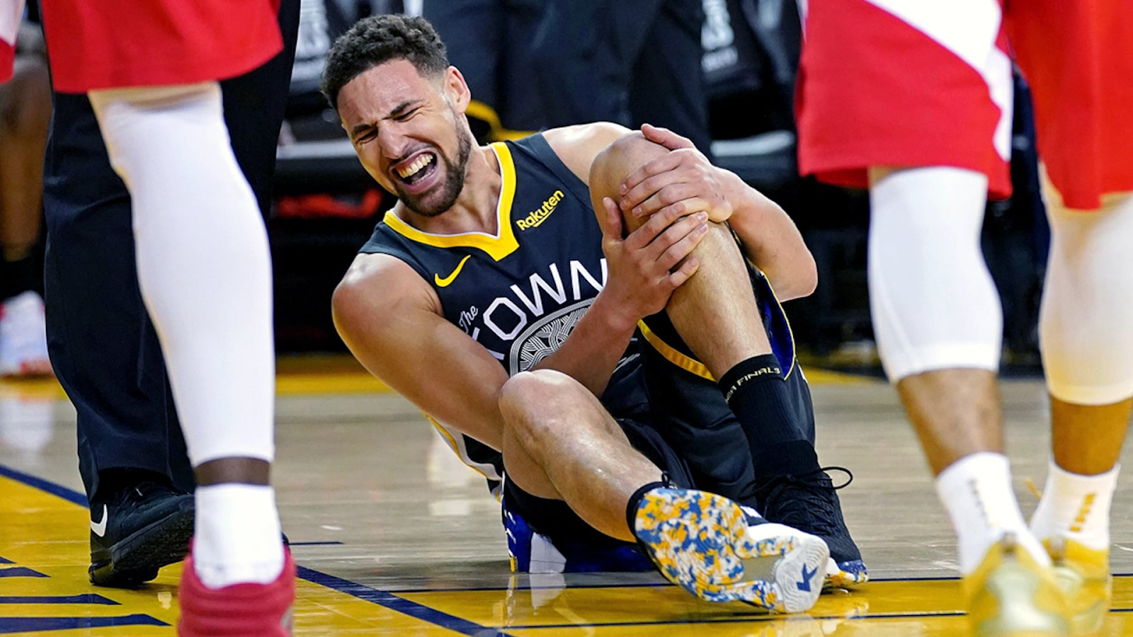 NBA player, Klay Thompson, injured after a dunk.