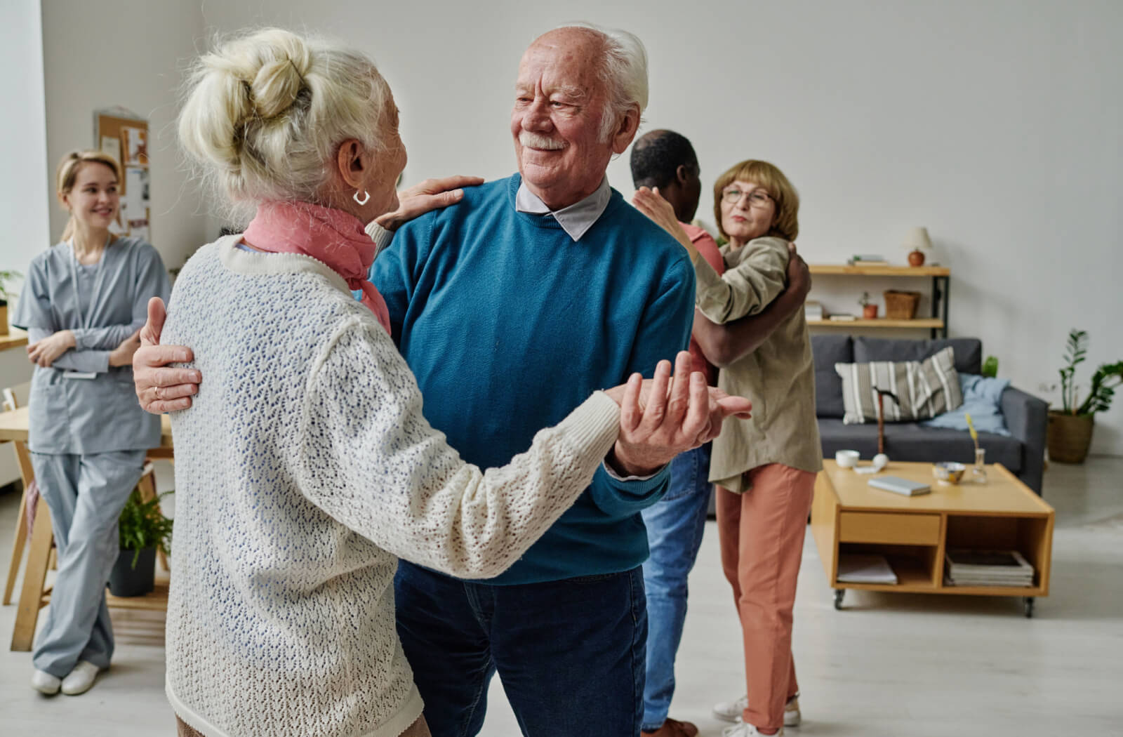 A pair of older adults during a dance class for aerobics in senior living.