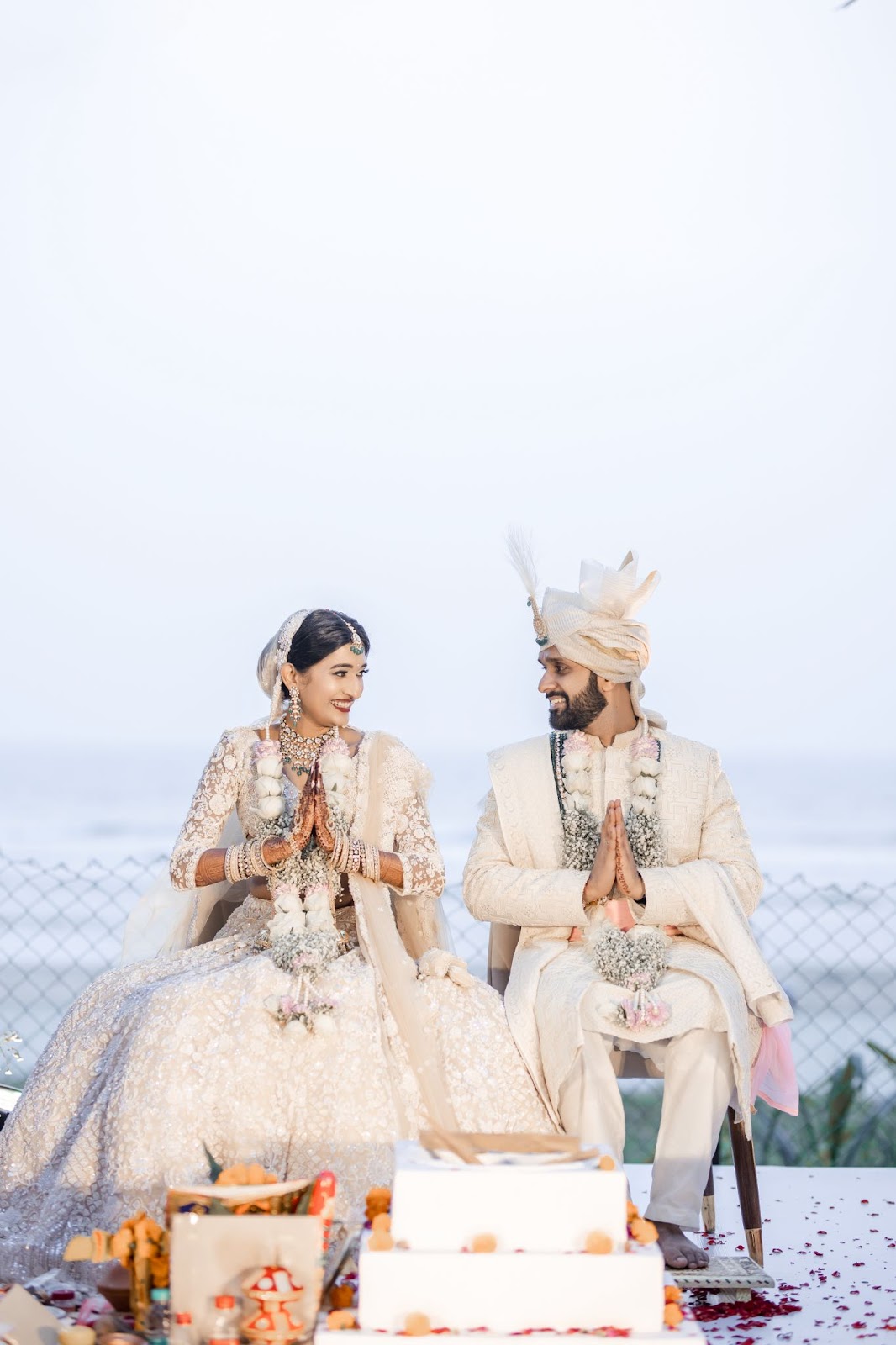 A bride’s gesture of respect, touching the groom’s feet in a beautifully captured wedding photograph for 2025