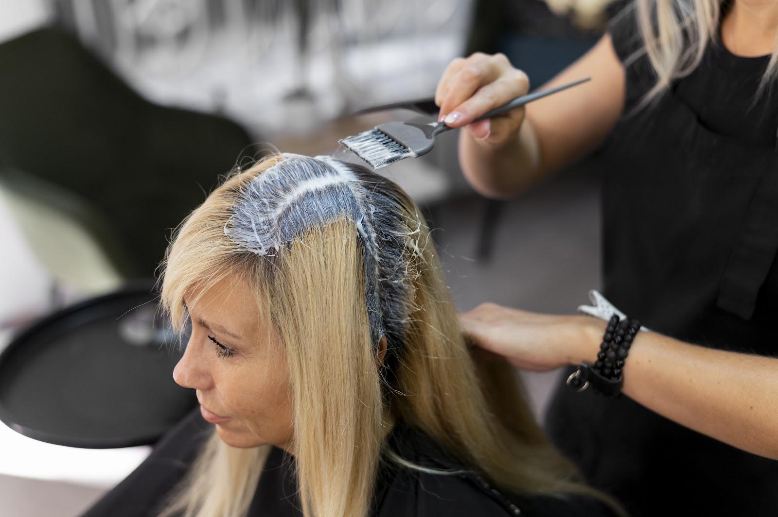 Woman getting her hair colored at a salon