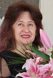 A person with long hair and a bouquet of flowersDescription automatically generated