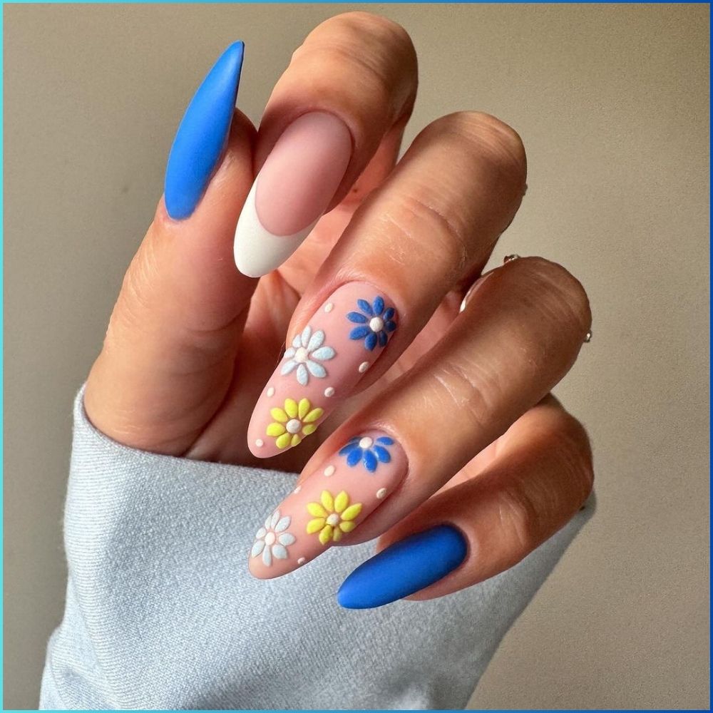 Close up of hands with flowered designed blue nails having Textured Daisy Flowers