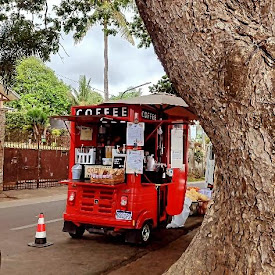 A red food truck parked on the side of a road

Description automatically generated