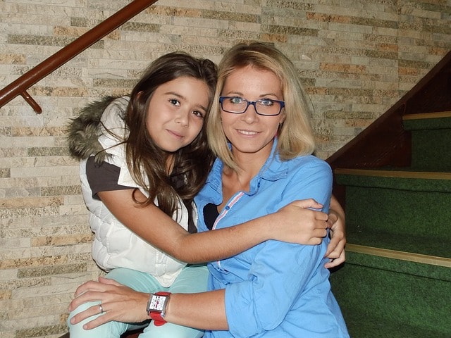 A woman holds her daughter during a rehab visit