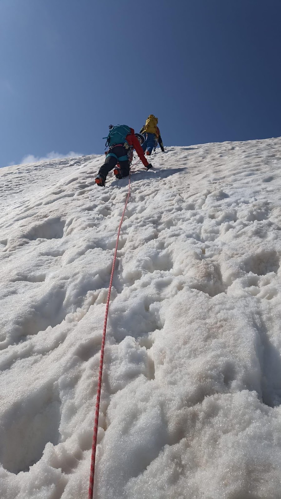 A group of people climbing a mountainAI-generated content may be incorrect.