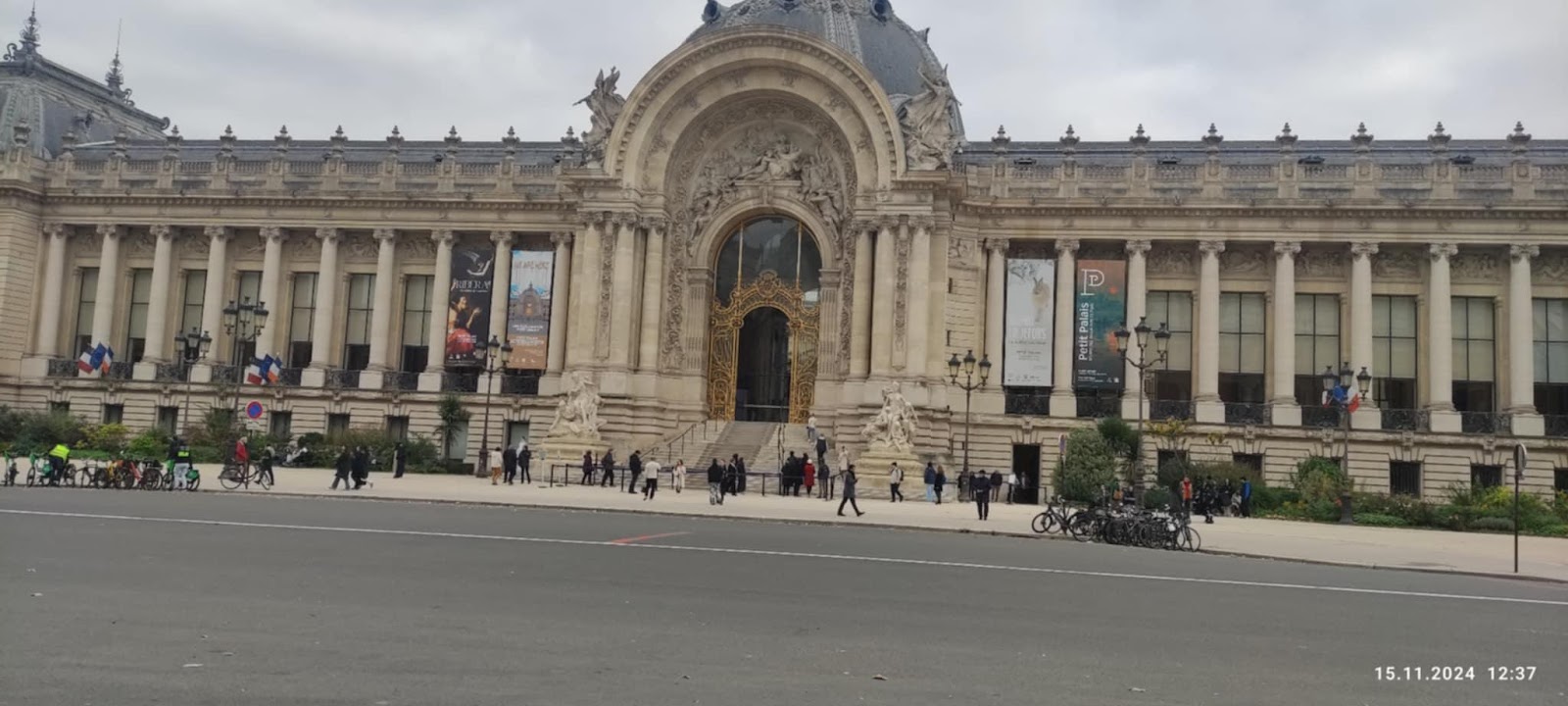 A large building with columns and a street with Petit Palais in the backgroundDescription automatically generated