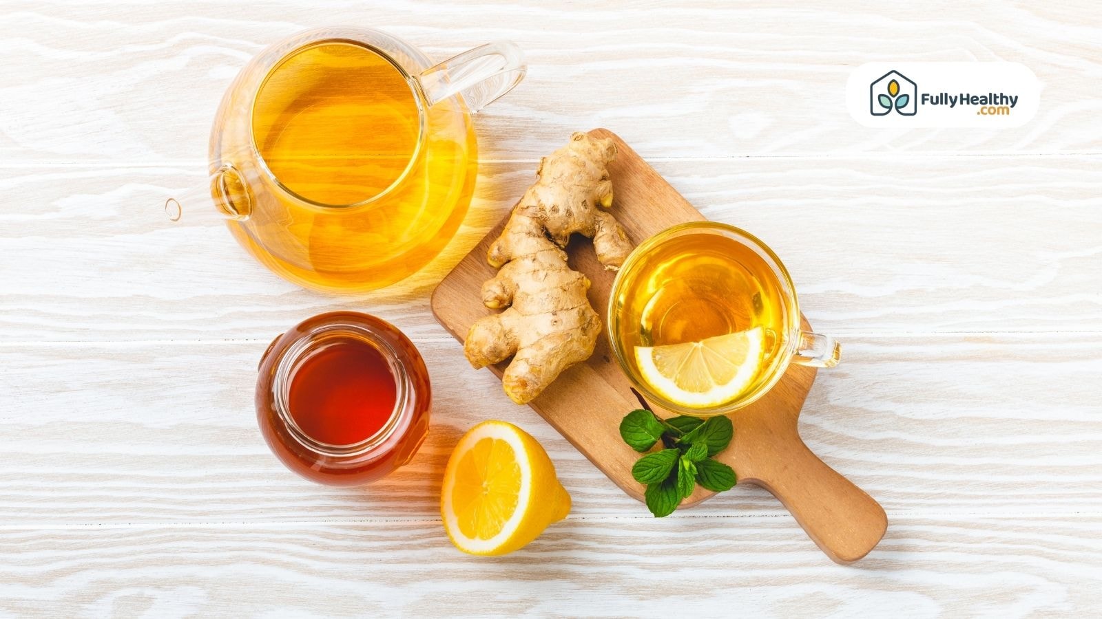 Glass teapot with ginger tea lemon honey and fresh ginger