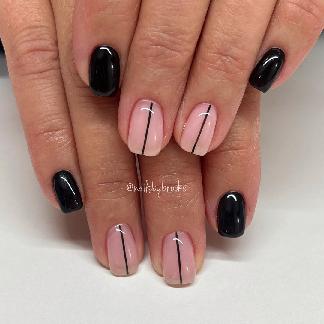 Close-up of a person's hands with black nails having Minimalist Black Lines and Shapes