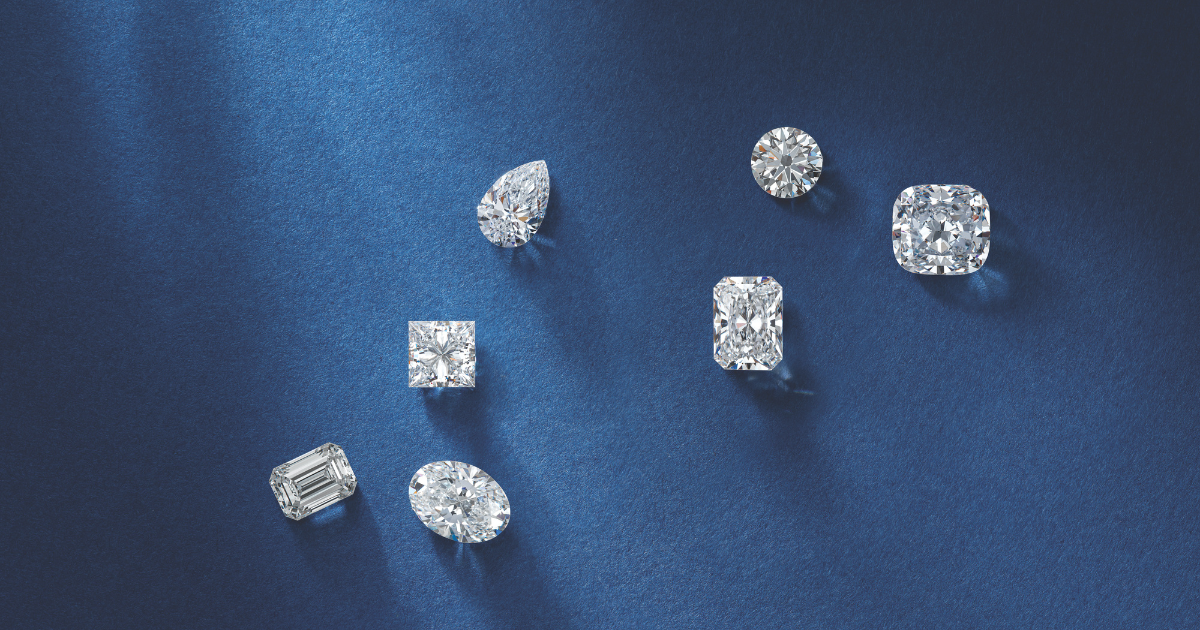 Several loose diamonds in various shapes and cuts on a blue background