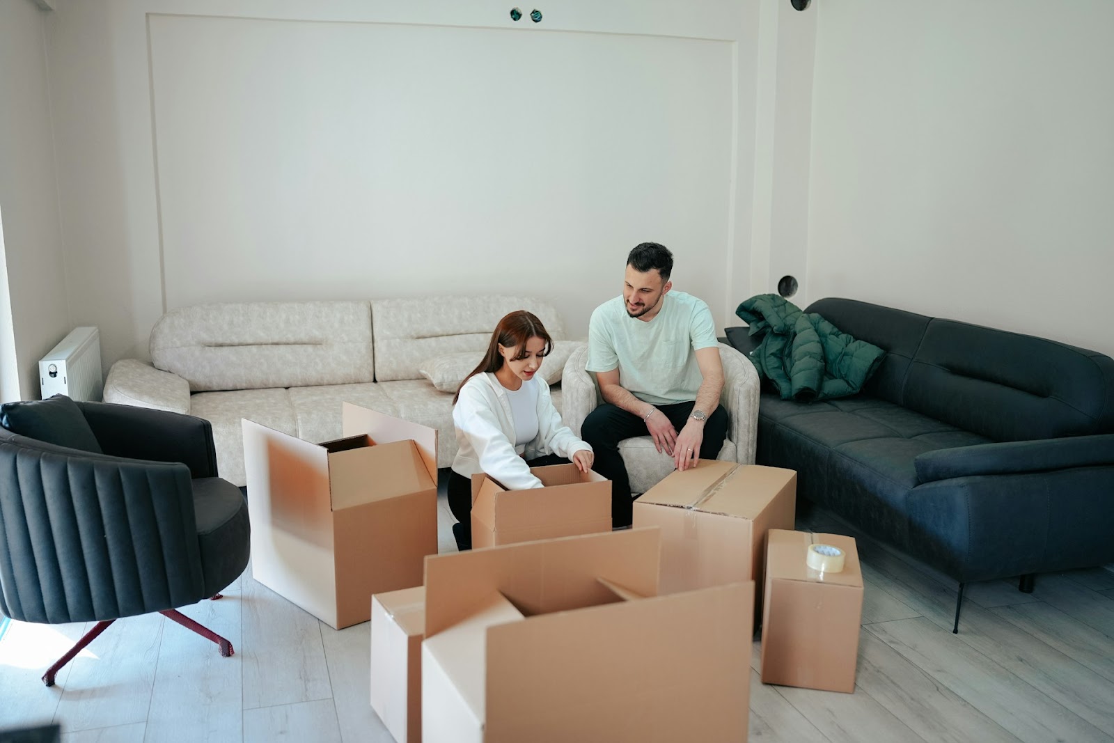 A couple packing boxes to put into self-storage as they move house