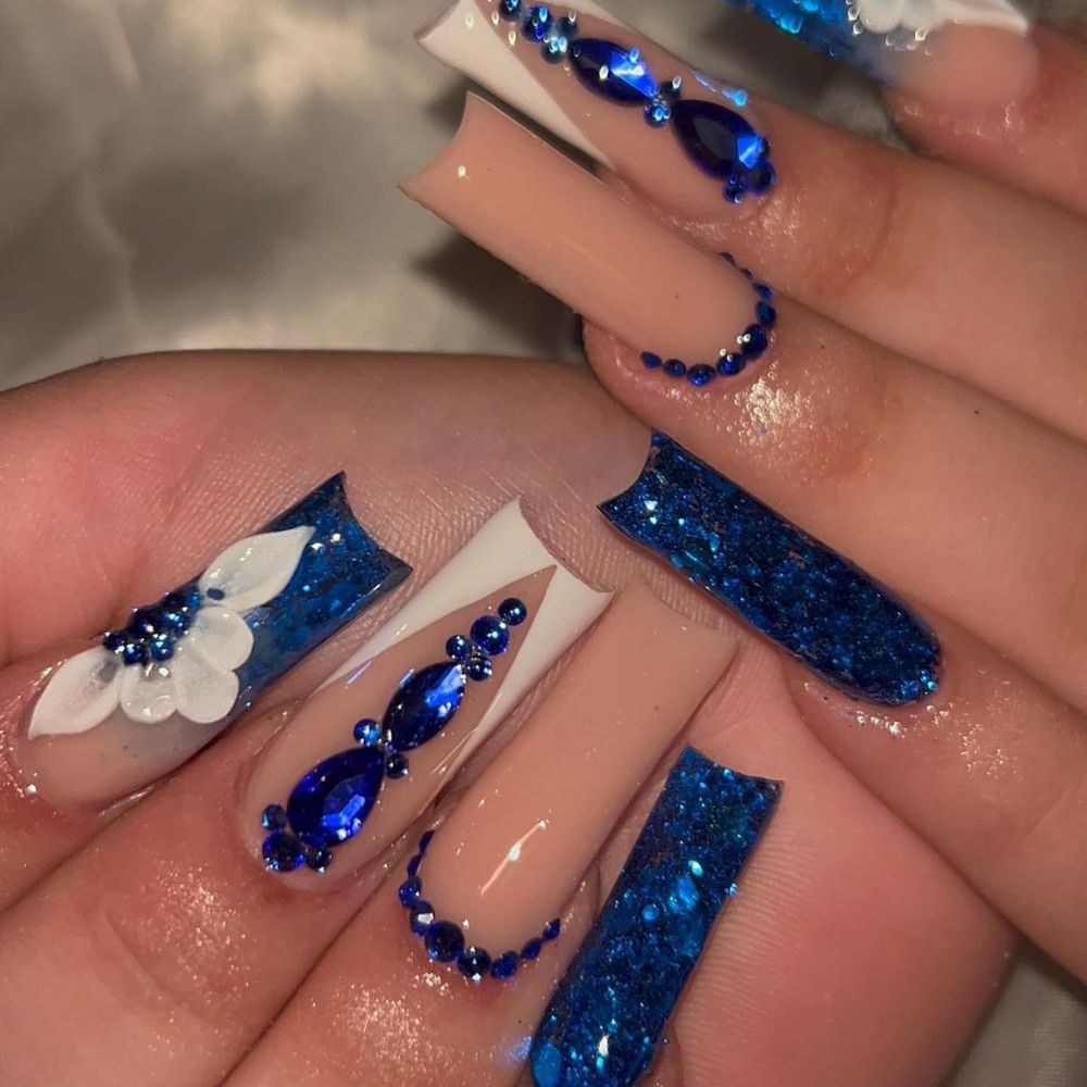 Close up of hands with blue winter nails having Sparks on nails