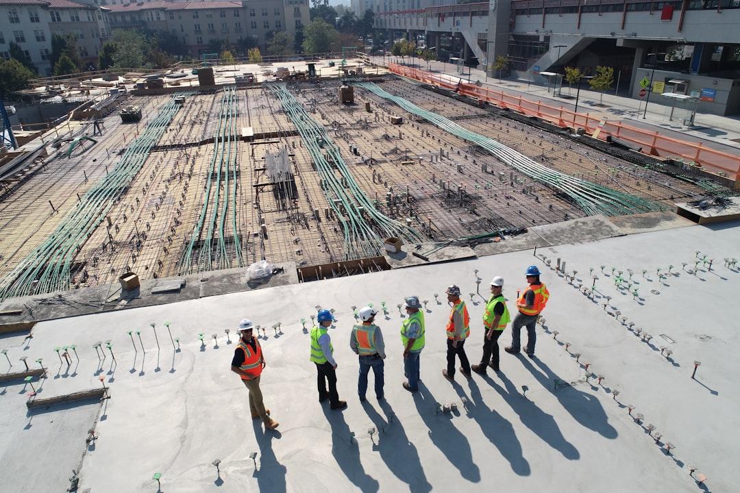 A group of people standing on a roof<br />
<br />
Description automatically generated