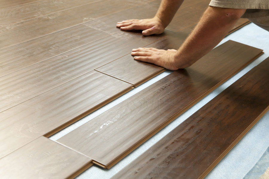 A man installing laminate flooring 