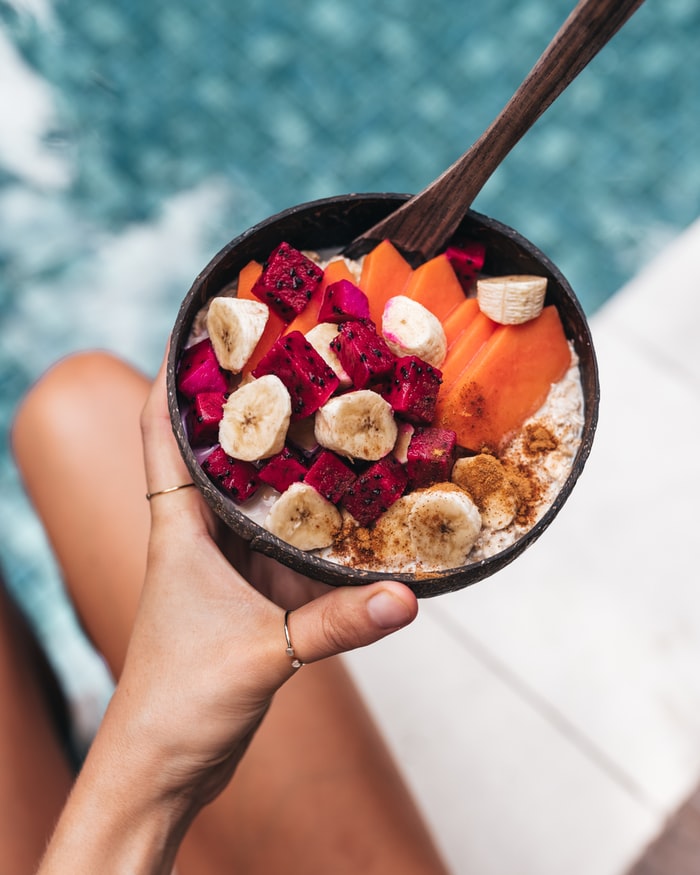 Oatmeal with fruits like banana, dragon fruit and papaya