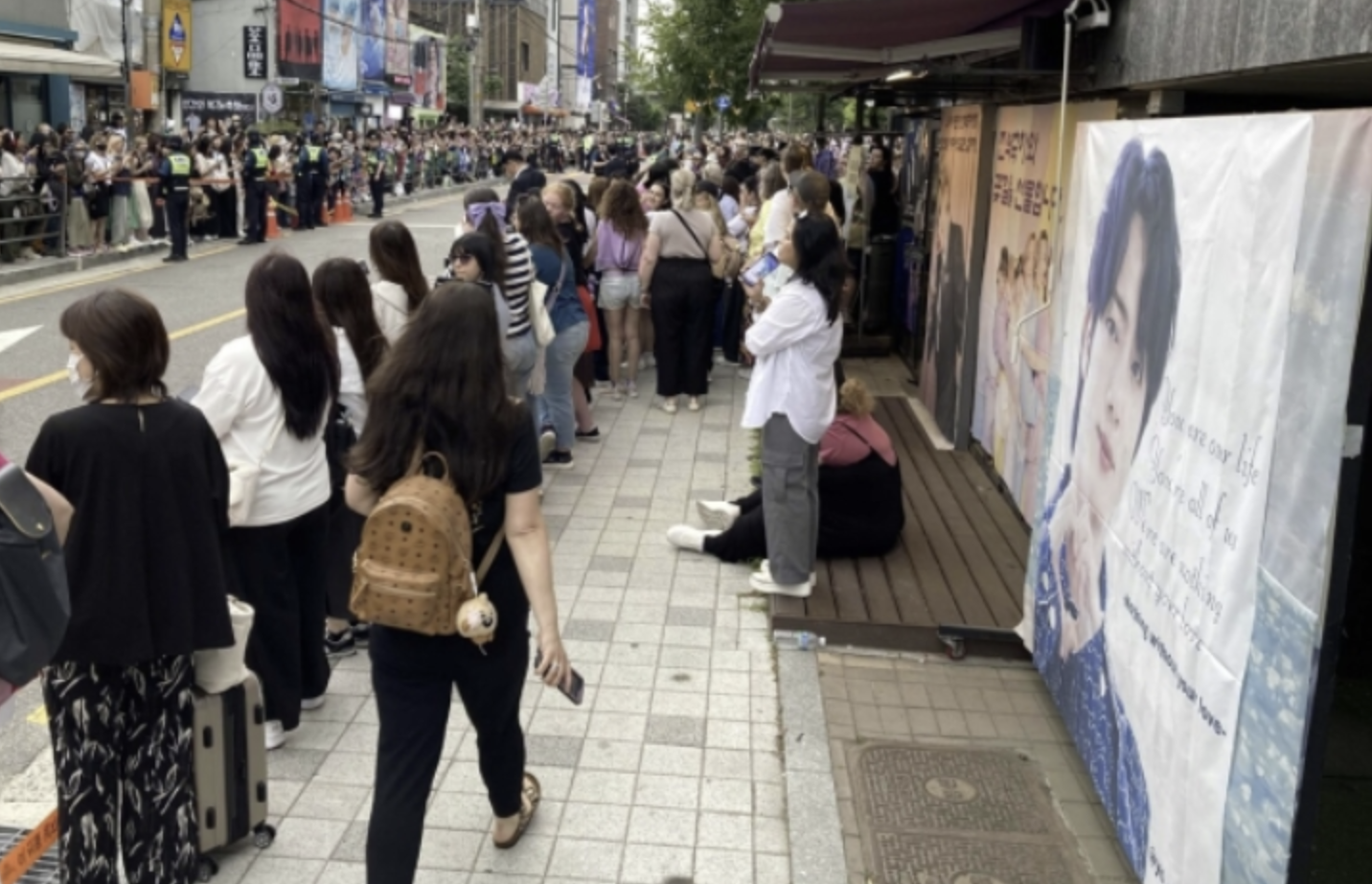 A picture of fans at HYBE  to welcome BTS RM and  V