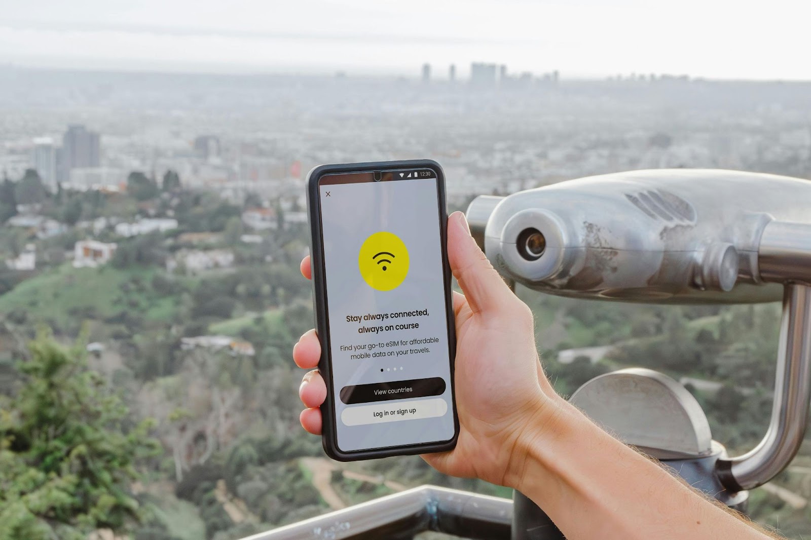 A hand holding a smart phone connecting to eSIM
