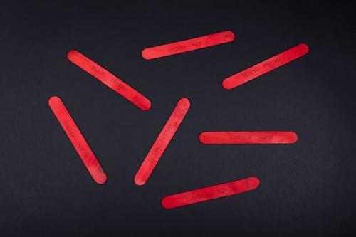 Free Red Popsicle Sticks on Black Table Stock Photo