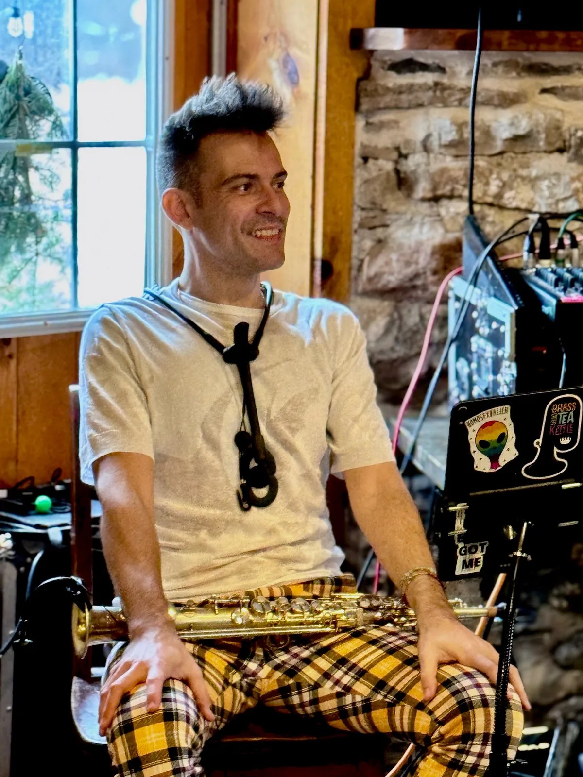 Image of Fracesco Cellarosi smiling with a saxophone in his lap. 