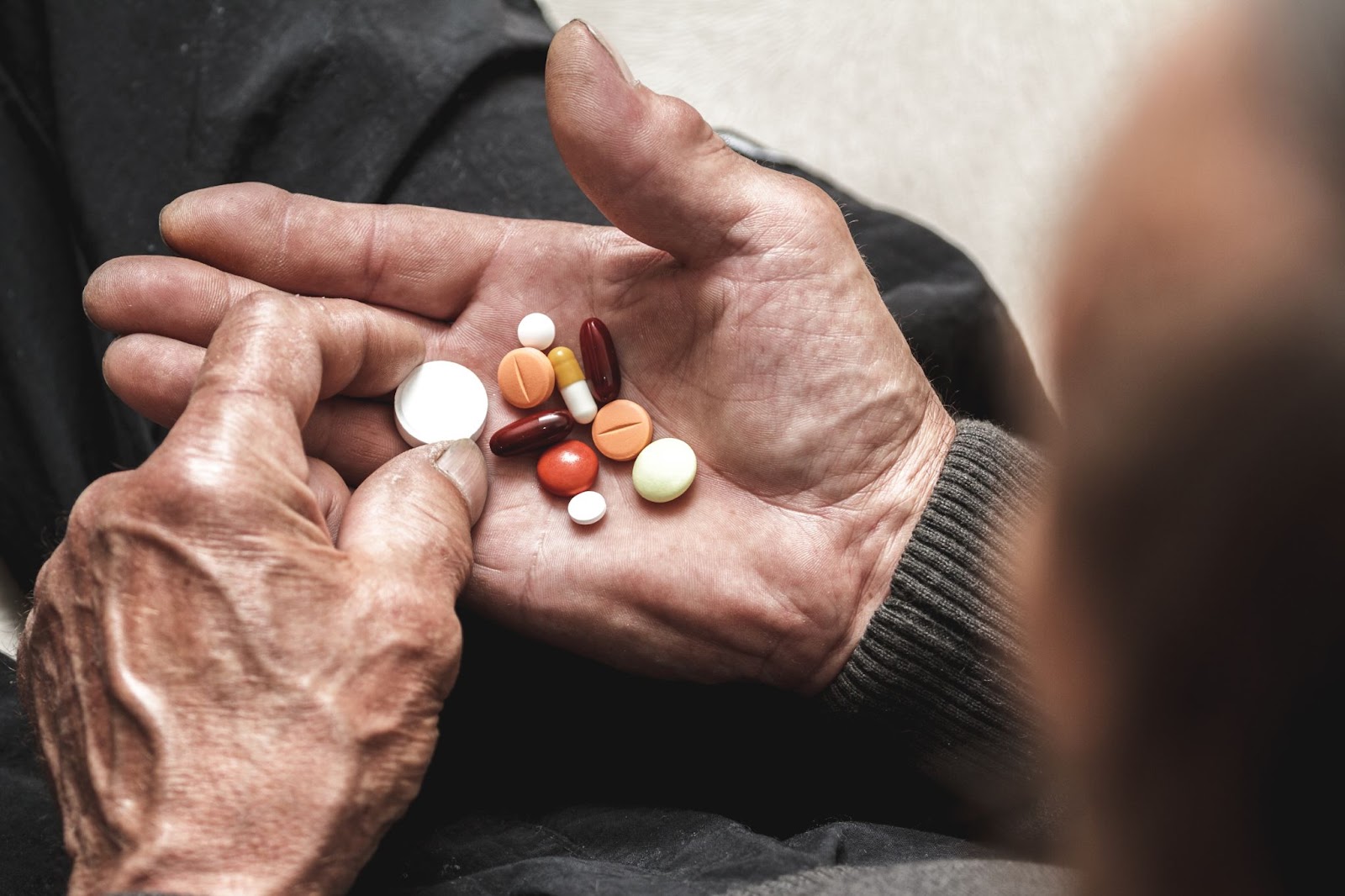 A senior with a handful of different medications to keep track of.