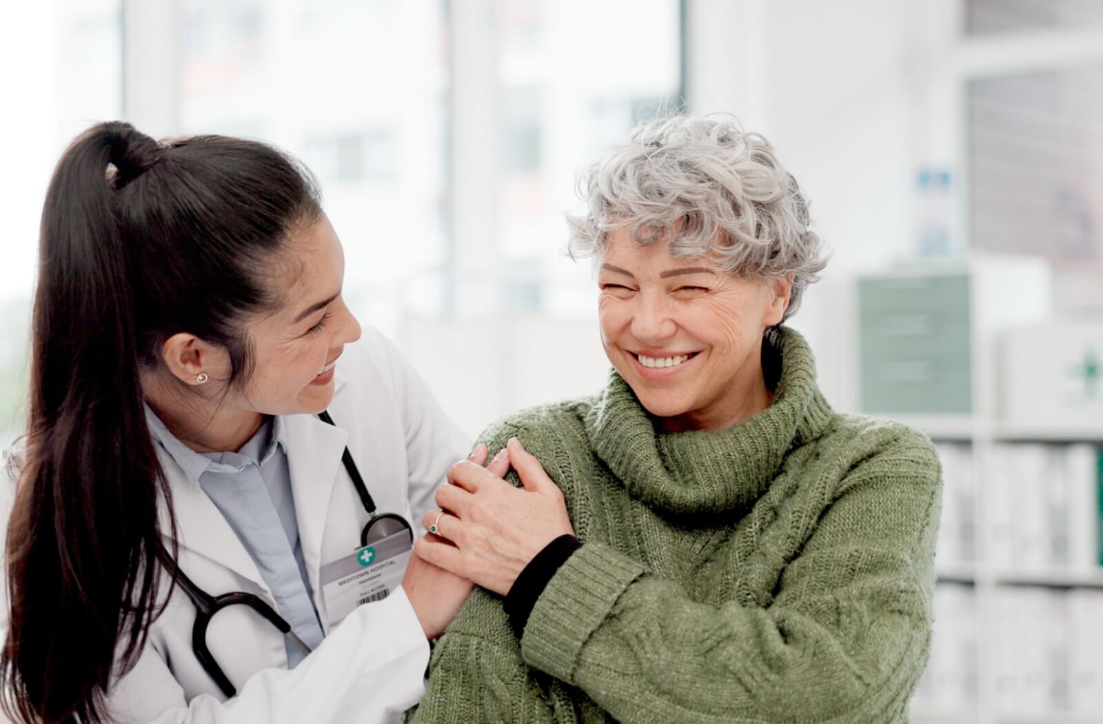 A senior woman getting support with medication management from a nurse at an assisted living community.