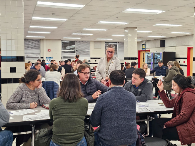 Dr. Reid observing participants at a Boundary Review Community meeting at Madison High School. 