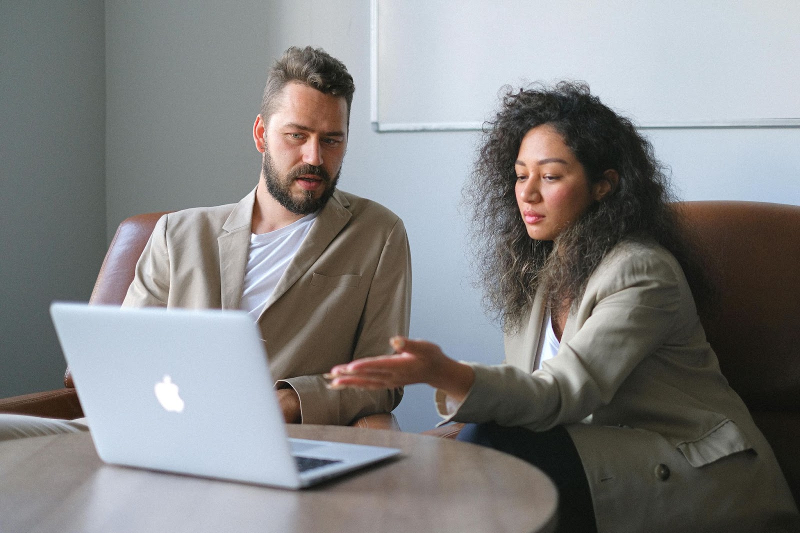 image of two people looking at a laptop screen.