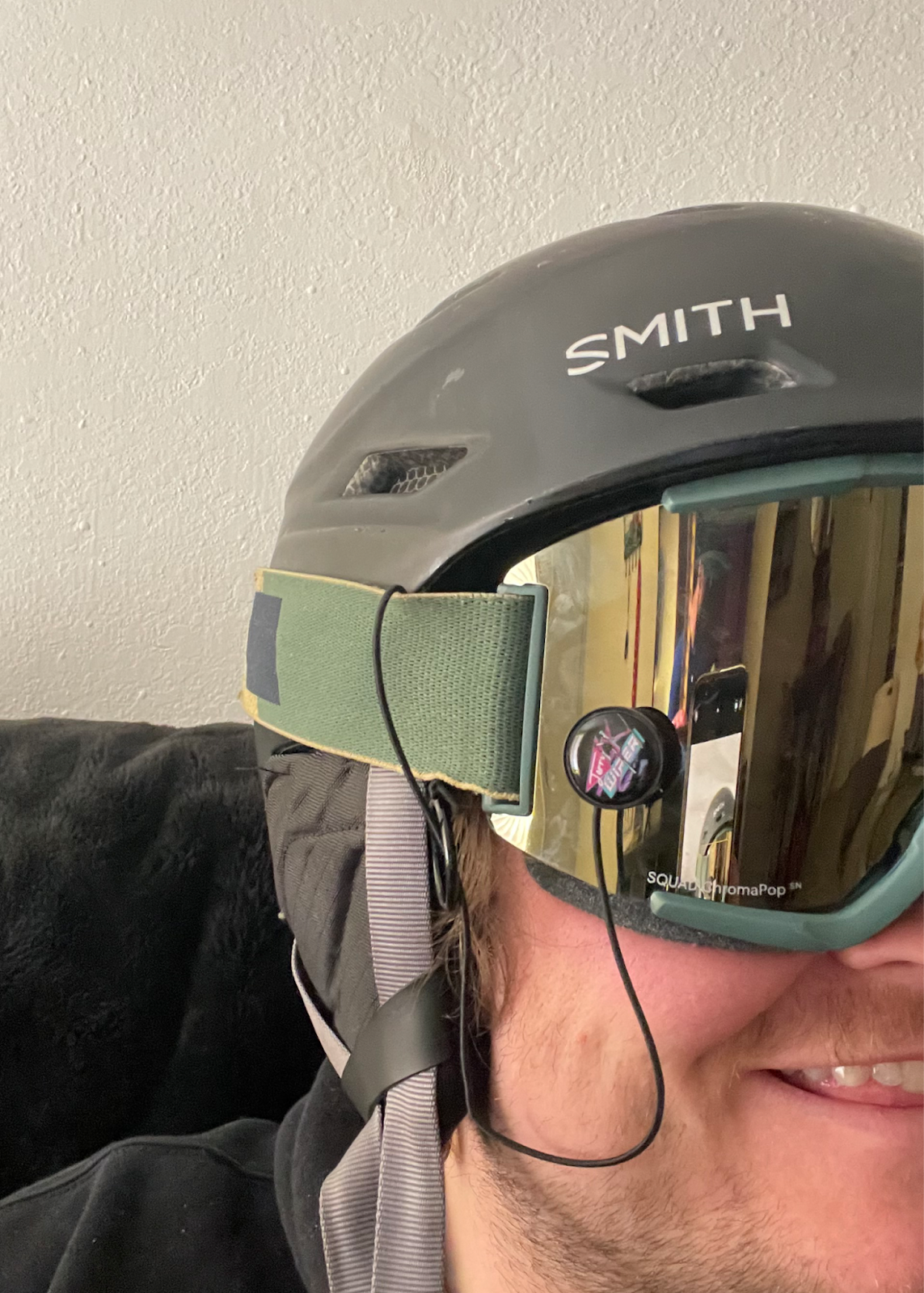 This is an image of the Jerry Wiper attached to goggles. A person is wearing the snow goggles with a helmet on