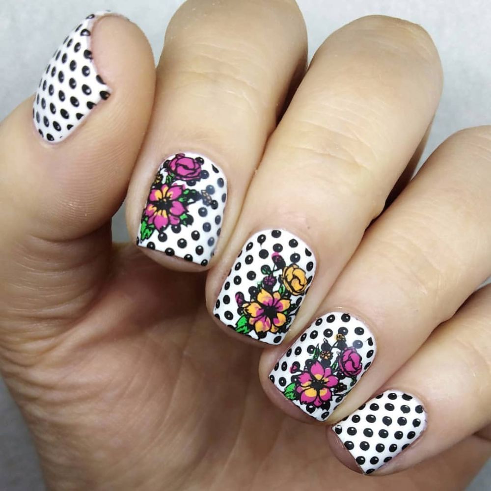 Close up of flowered short nail design with Polka dots with flowers