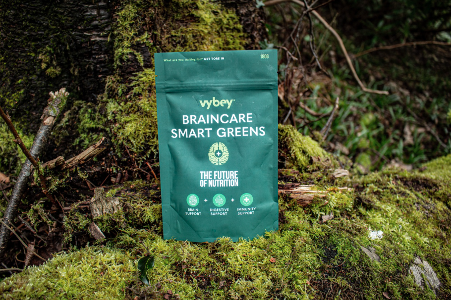 Braincare Smart Greens powder packaging displayed against a lush, mossy background, emphasizing its natural, nutrient-dense super greens formula designed to support brain health, energy, and overall wellness.