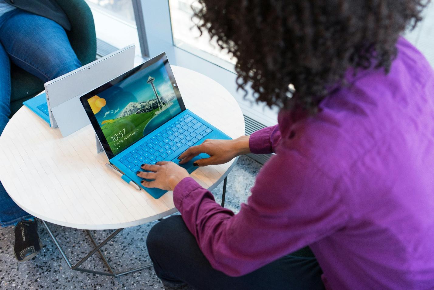 person’s hands typing on a laptop