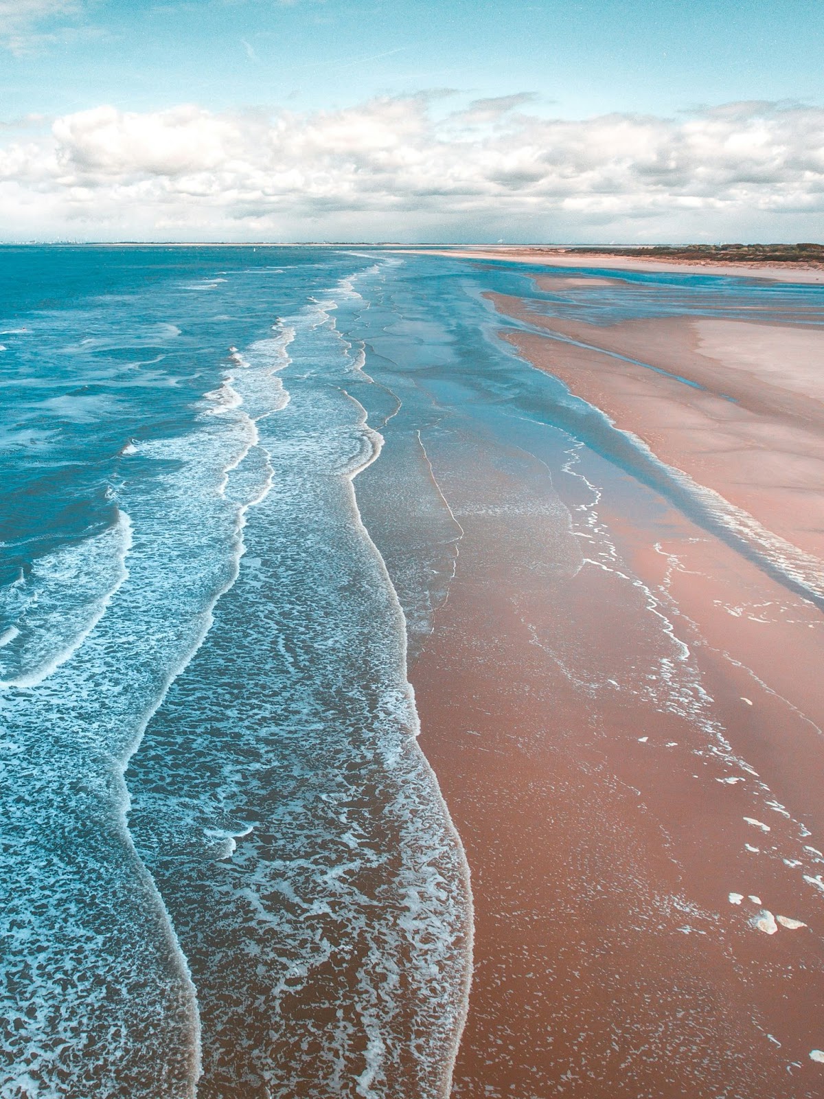 Escape to 17 Mile Beach in Barbuda with pink-tinged sands and crystal-clear waters.