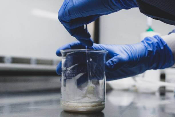 Close-up of a pharmacist measuring ingredients for a compounded prescription, highlighting the art and science of personalized medicine.