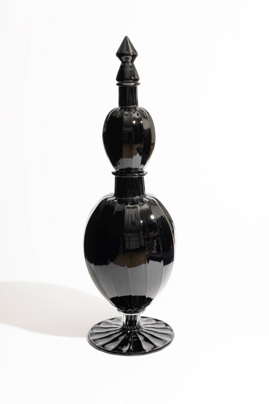 Image: "Black Star Line" by Crystal Z Campbell, 2024. Hand-blown black glass, made at the Museum of Glass, Tacoma, WA. Two-tired oblong black vase. Photo by Ian Lewis. Courtesy of Crystal Z Campbell.