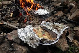 food wrapped in foil and place on fire as emergency cooking hacks when camping