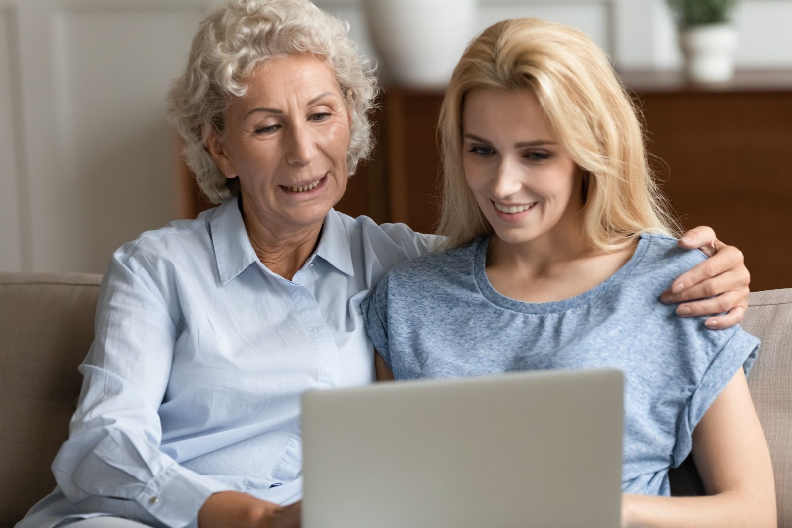 An adult child shows her senior mother how a computer program can enhance their time together and when they're apart.