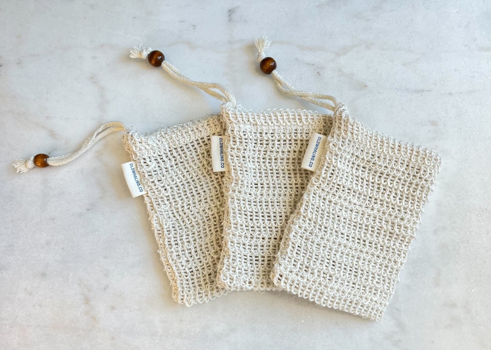 Natural fiber soap pouch in flat lay on marble counter