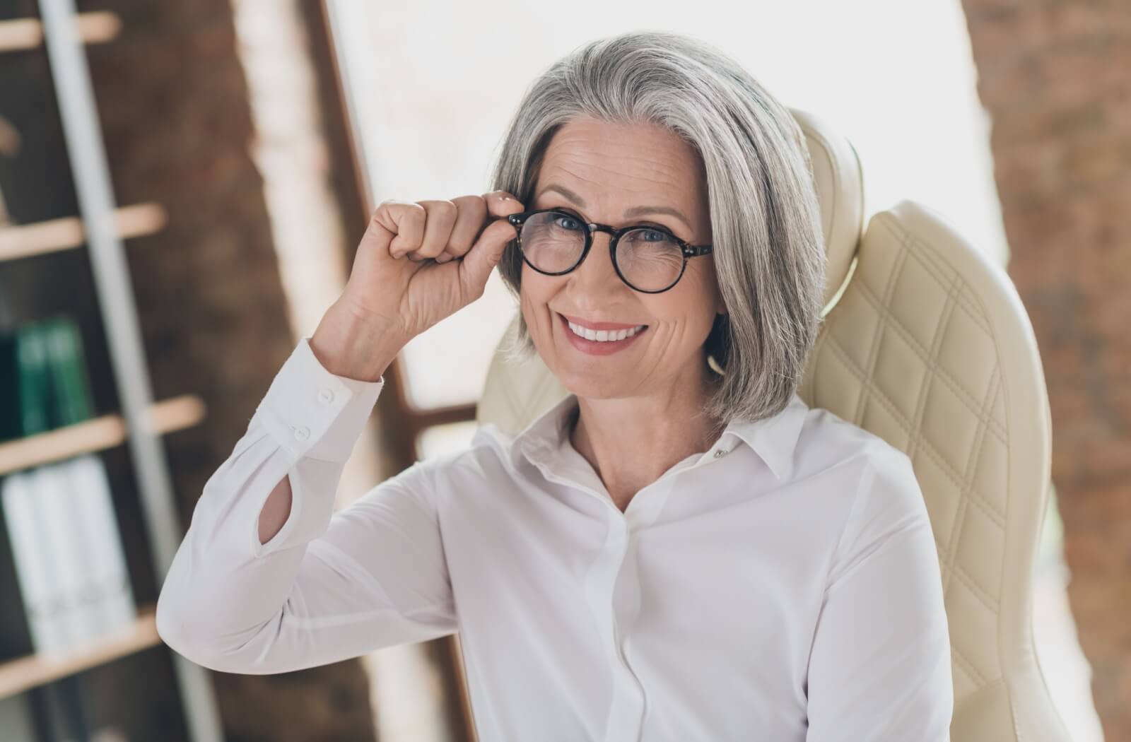 An older adult smiles as they enjoy the vision freedom their new progressive lenses offer.