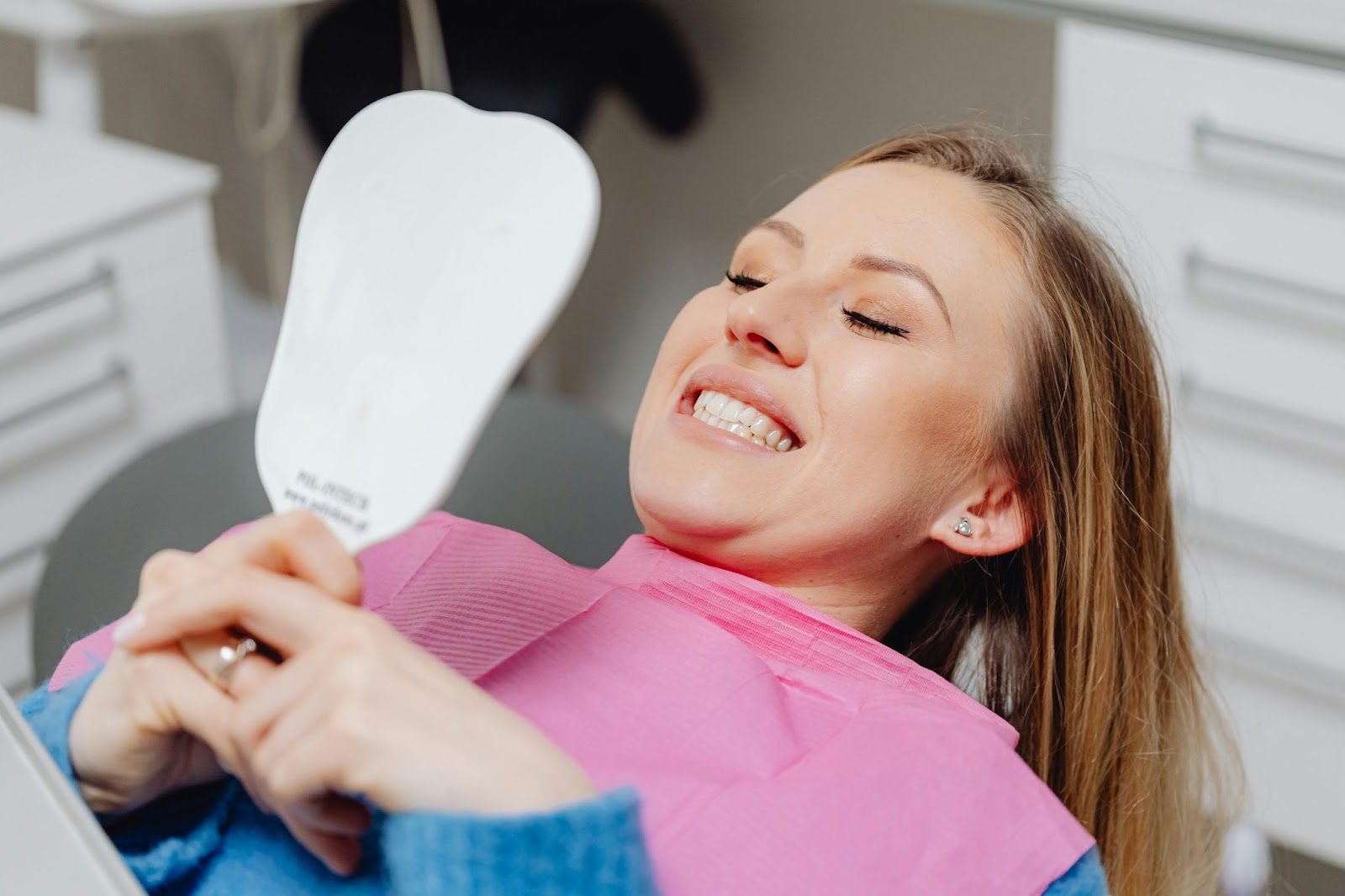 Person looking at mirror in a dental office